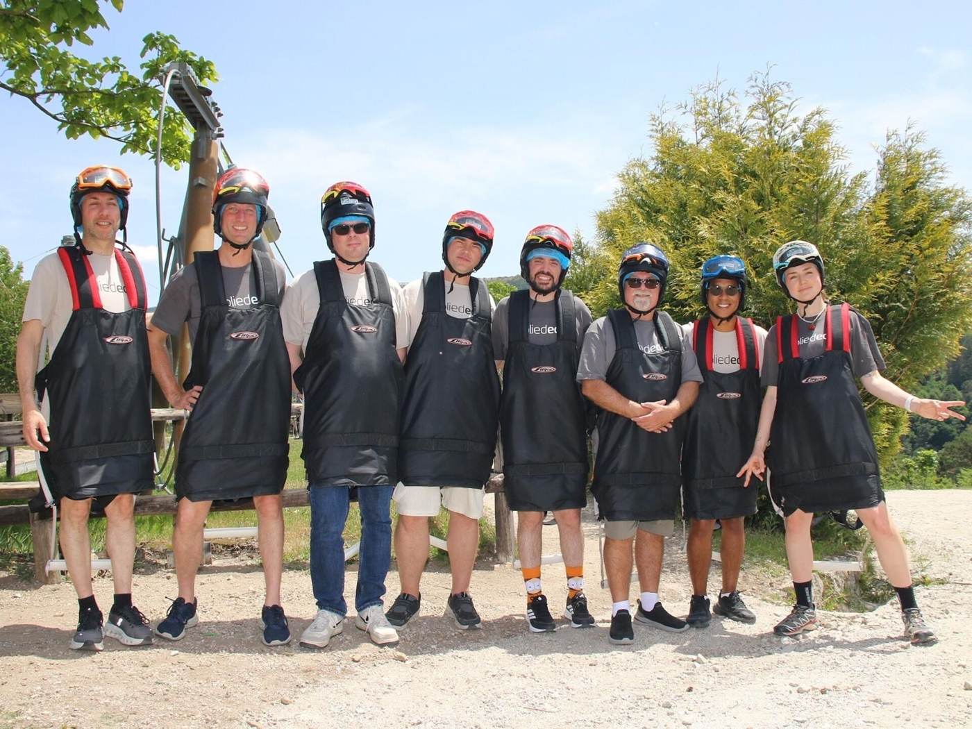 Colleagues lined up in helmets and aprons at the adventure park