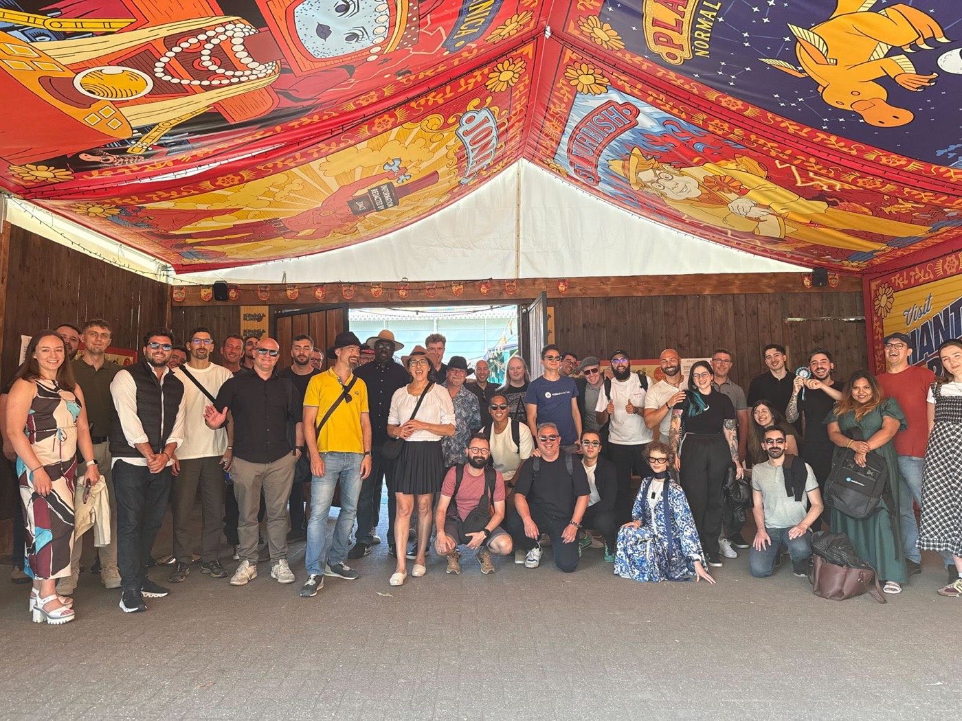 The team gathered under a colourful tent at the 10th anniversary